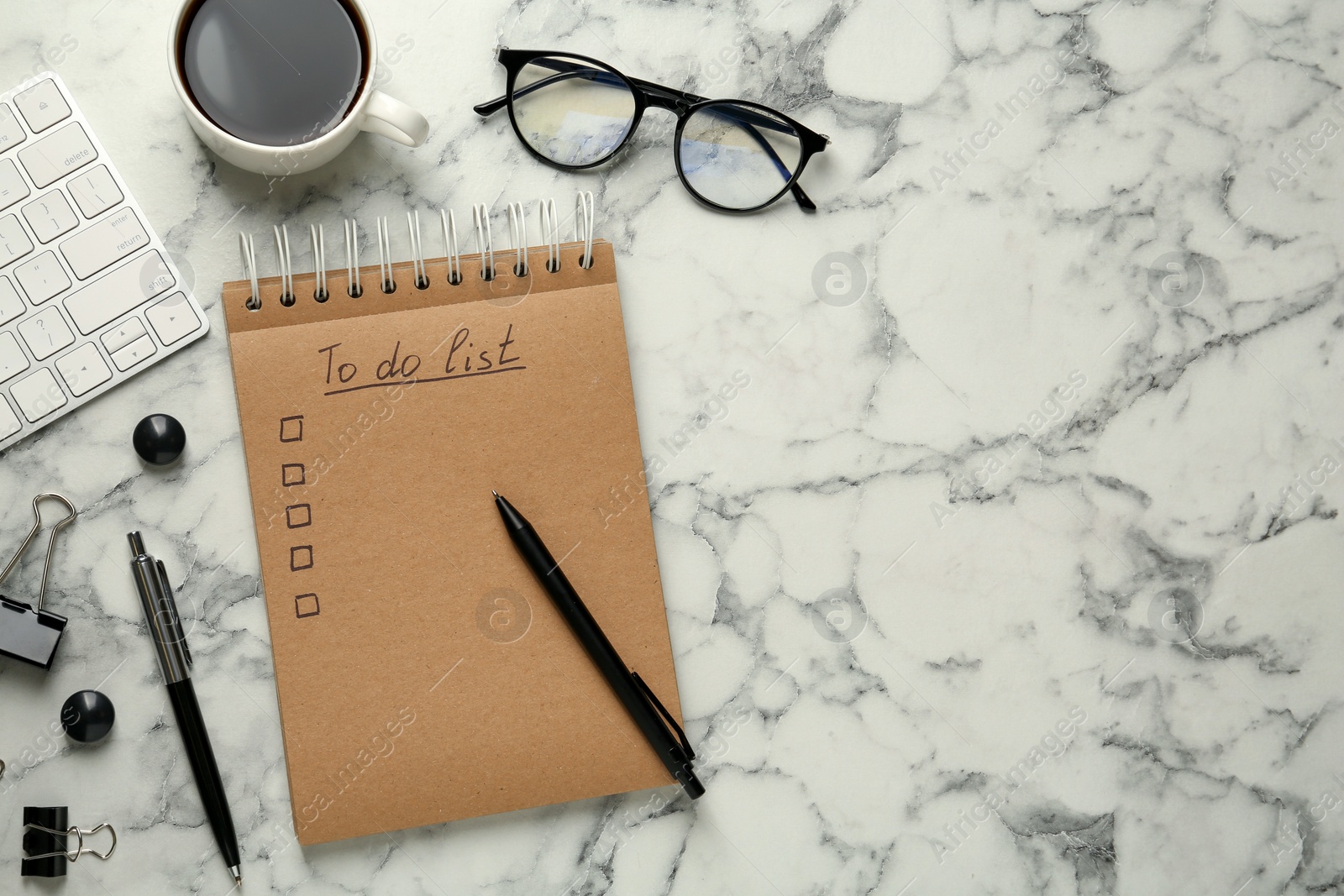 Photo of Flat lay composition with unfilled To Do list and cup of coffee on white marble table, space for text