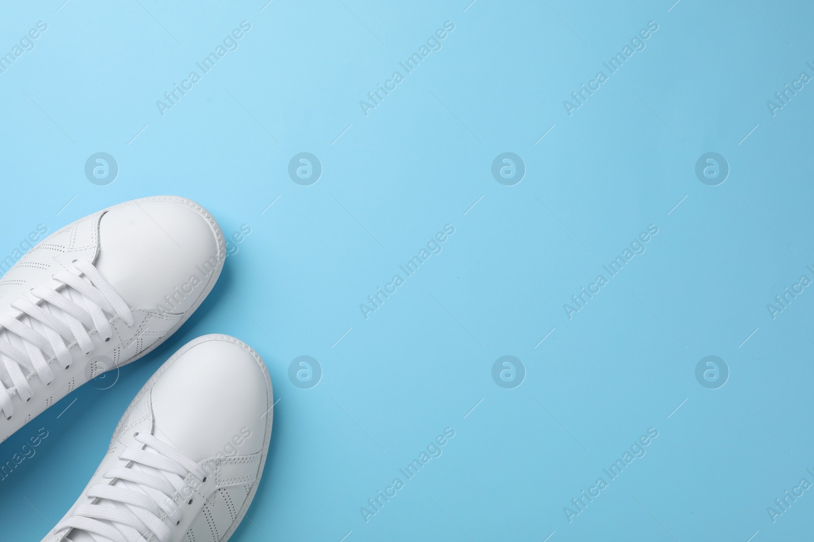 Photo of Pair of sneakers on color background, flat lay. Space for text