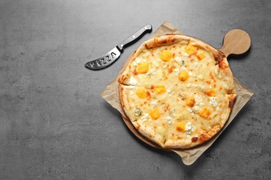 Hot cheese pizza Margherita on grey background, top view. Space for text