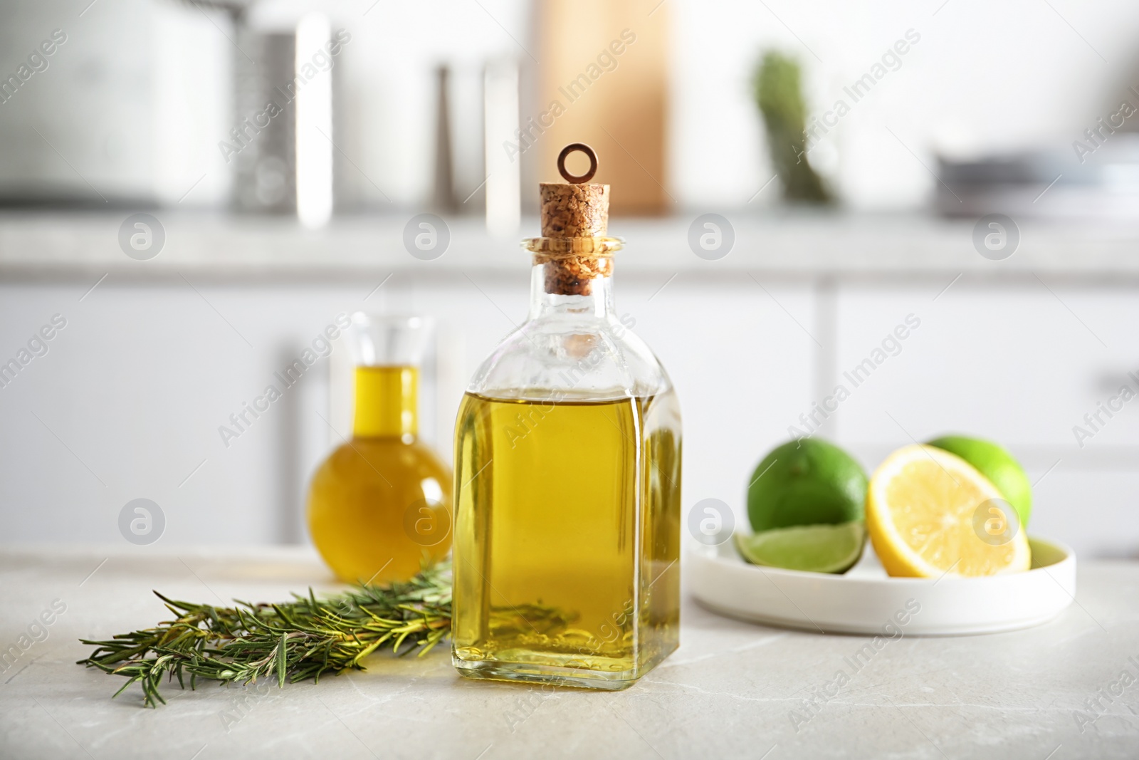 Photo of Composition with fresh rosemary oil on table