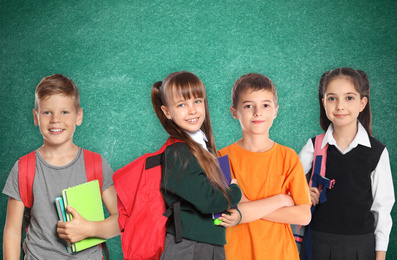 Image of Group of cute school children and chalkboard on background