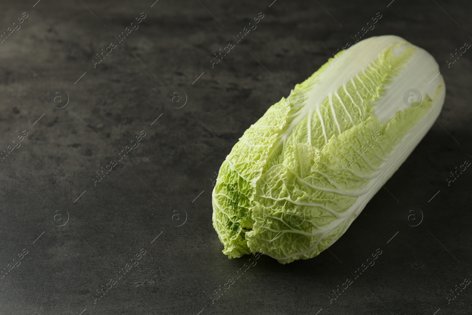 Photo of Fresh ripe Chinese cabbage on grey table, space for text