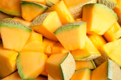 Photo of Pieces of tasty ripe melon as background, closeup