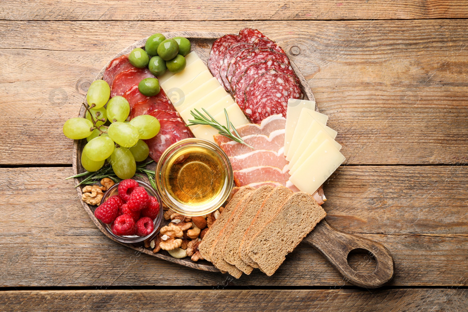 Photo of Snack set with delicious Parmesan cheese on wooden table, top view