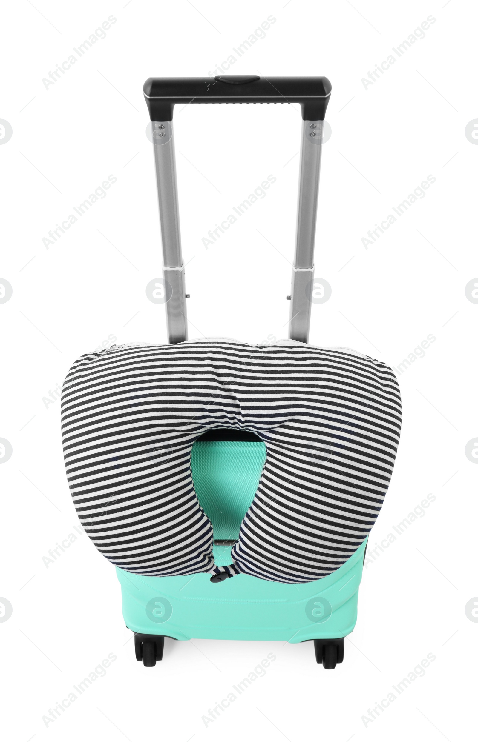 Photo of Soft travel pillow on turquoise suitcase isolated on white, above view