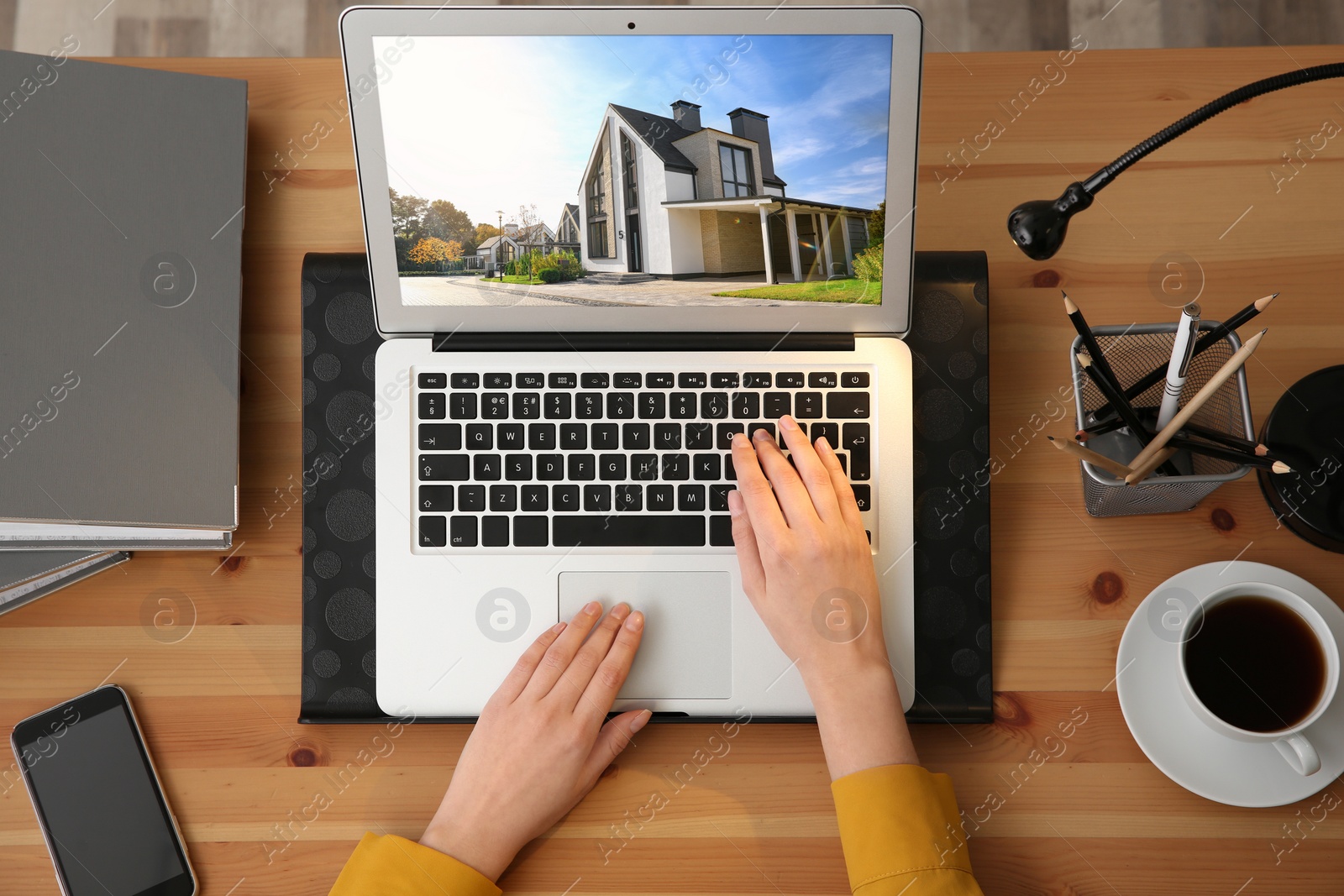 Image of Businesswoman or real estate agent looking through online property portfolio, top view