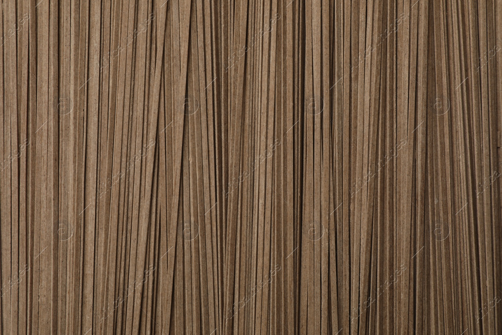 Photo of Uncooked buckwheat noodles (soba) as background, top view