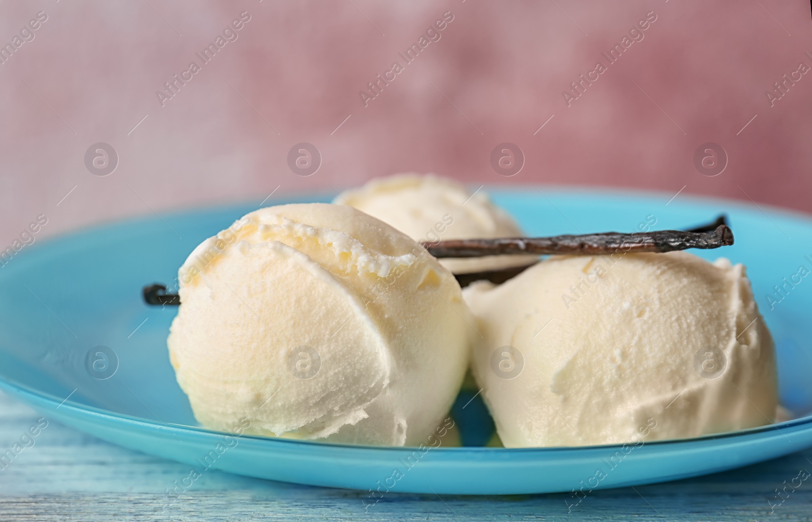 Photo of Plate with tasty vanilla ice cream on table, closeup