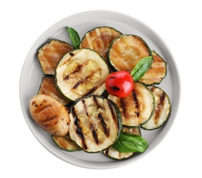 Photo of Plate of delicious grilled zucchini slices on white background, top view