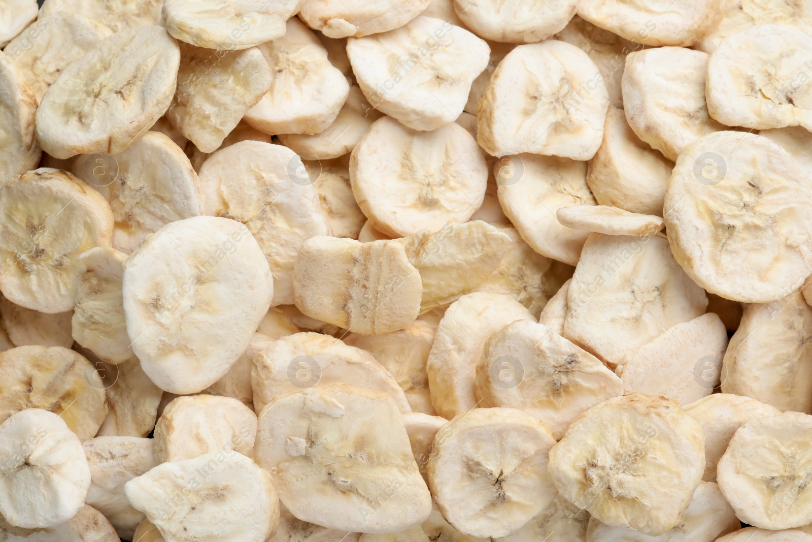 Photo of Closeup of freeze dried bananas as background, top view