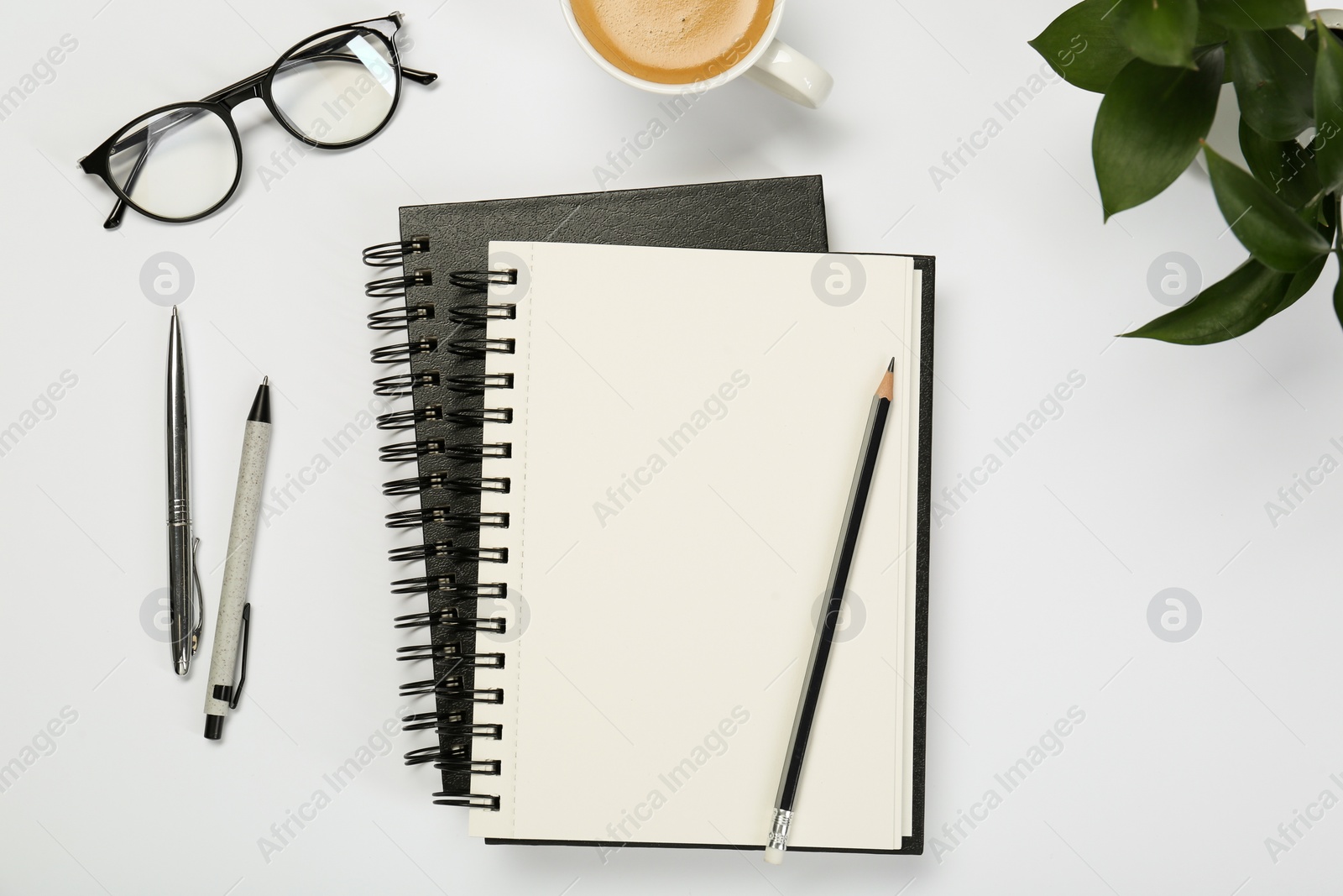 Photo of Flat lay composition with notebooks and coffee on white table