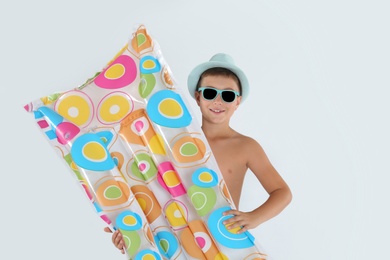 Photo of Cute little child with inflatable mattress on white background. Beach holiday