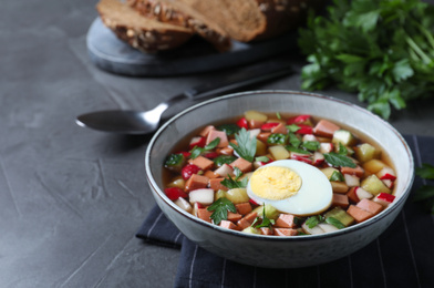 Delicious cold okroshka with kvass served on grey table. Traditional Russian summer soup