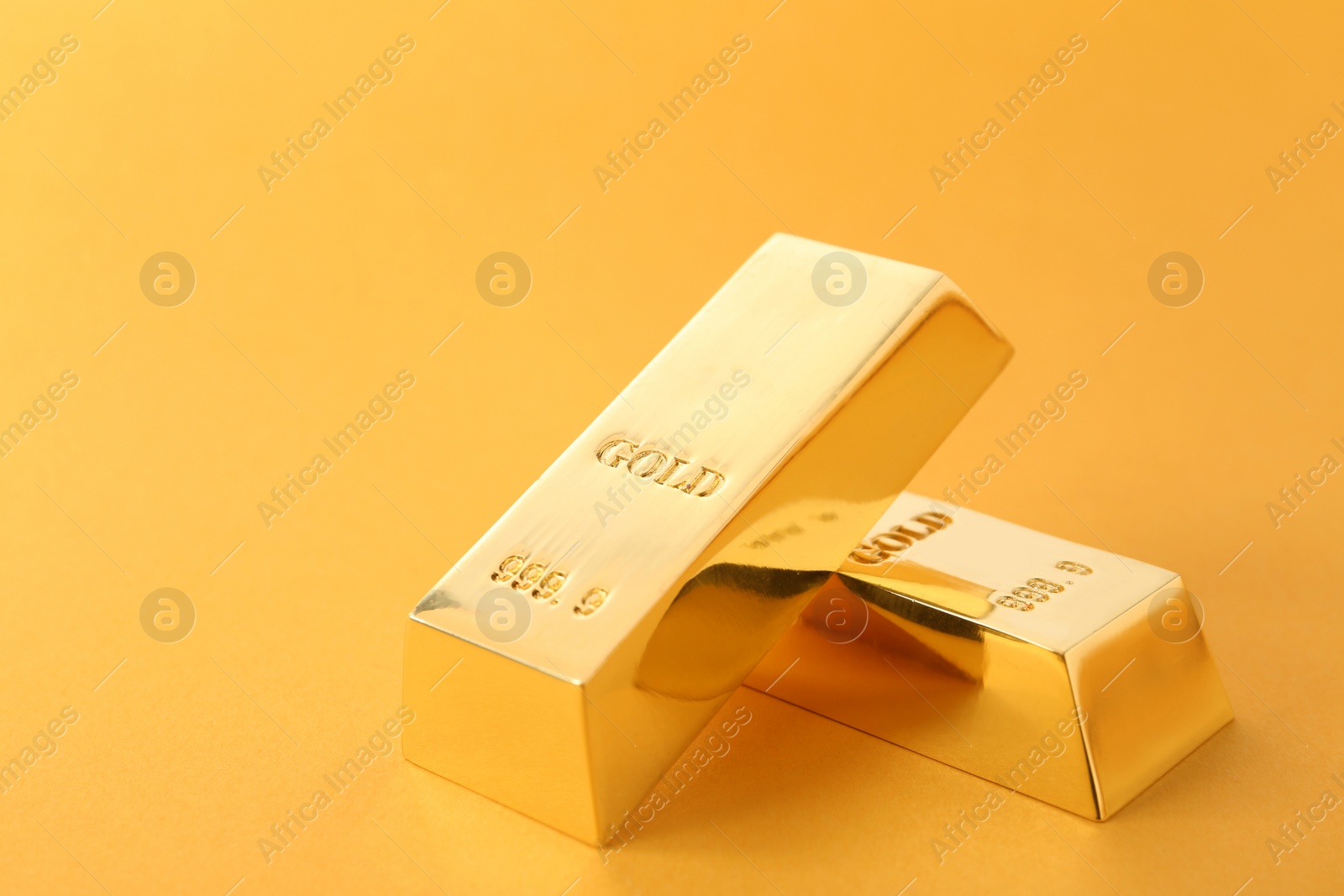 Photo of Precious shiny gold bars on color background. Space for text