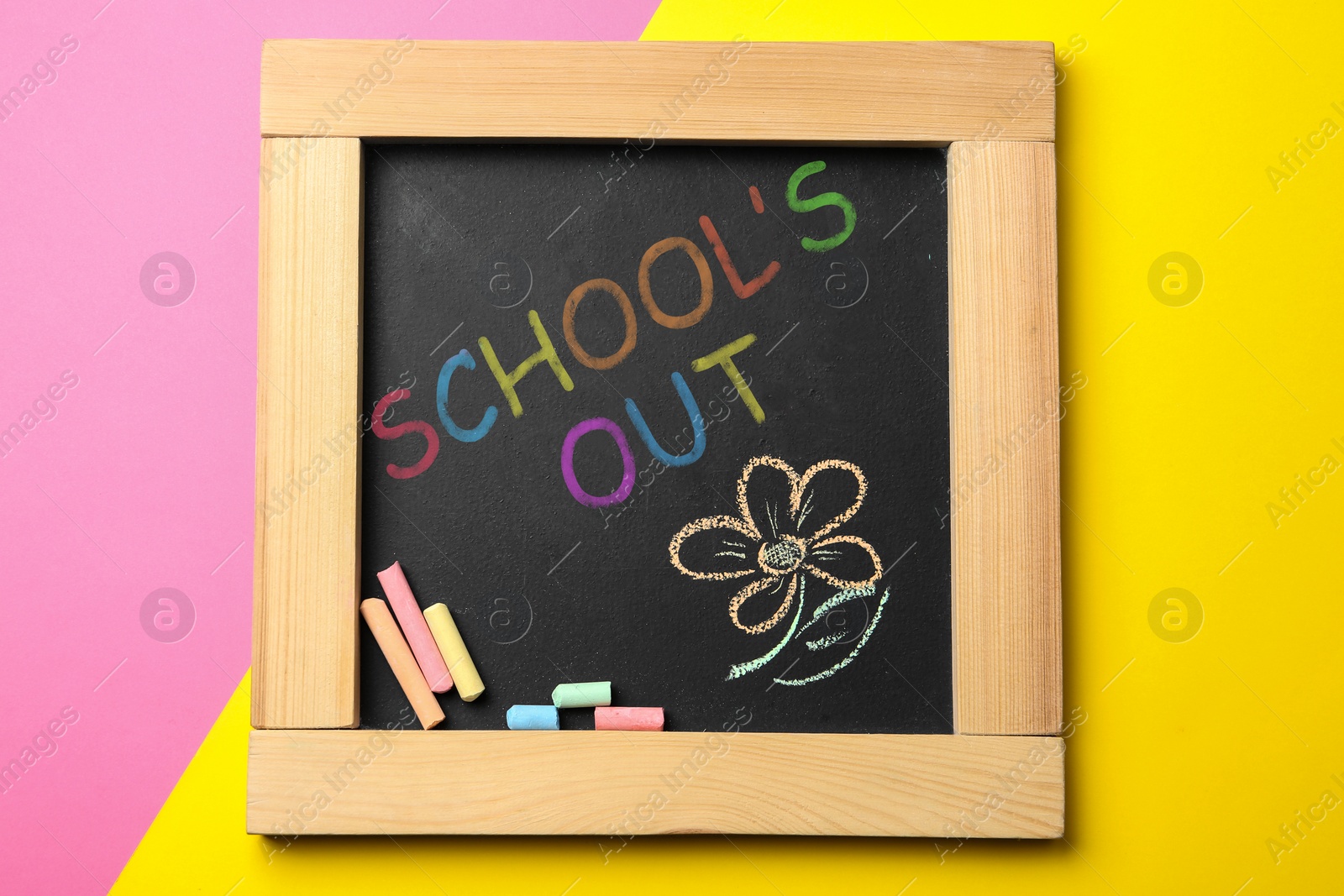 Image of Chalkboard with text SCHOOL'S OUT on color background, top view