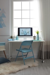Photo of Stylish workplace interior with modern computer on desk