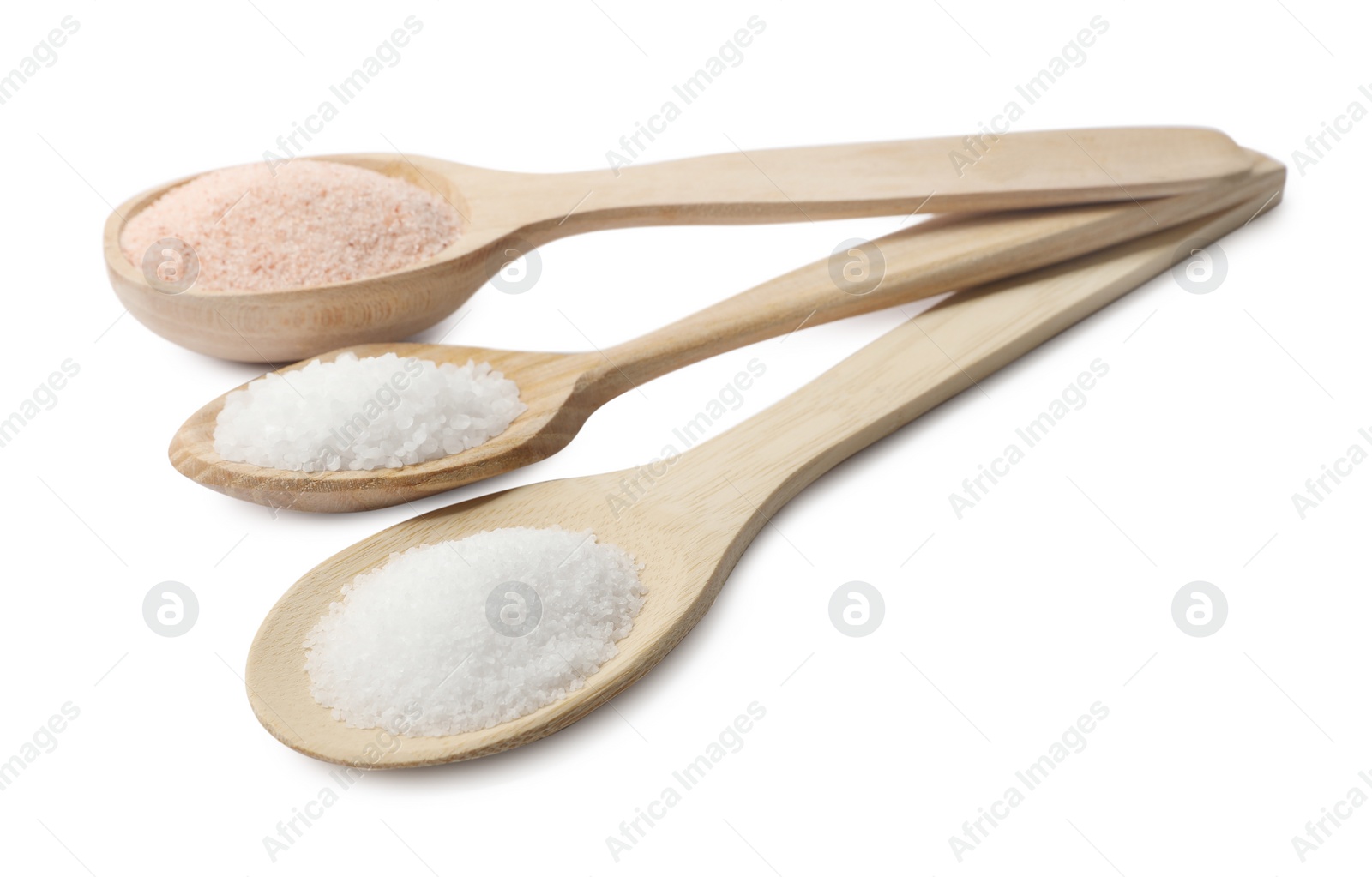 Photo of Different types of natural salt in wooden spoons isolated on white