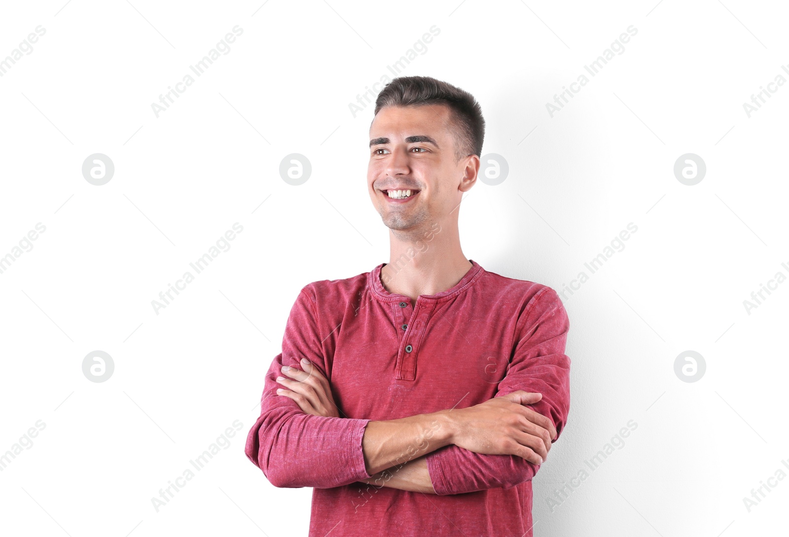 Photo of Handsome young man smiling on white background