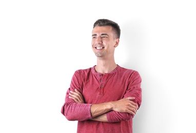 Handsome young man smiling on white background