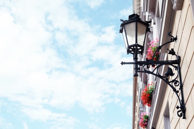 Vintage street lamp on wall of big building