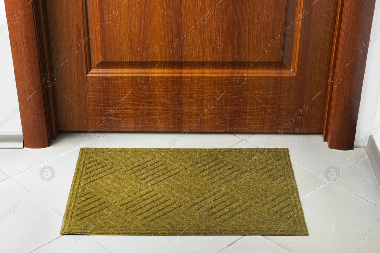 Photo of Clean door mat on floor near entrance