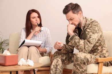 Psychologist working with military officer in office