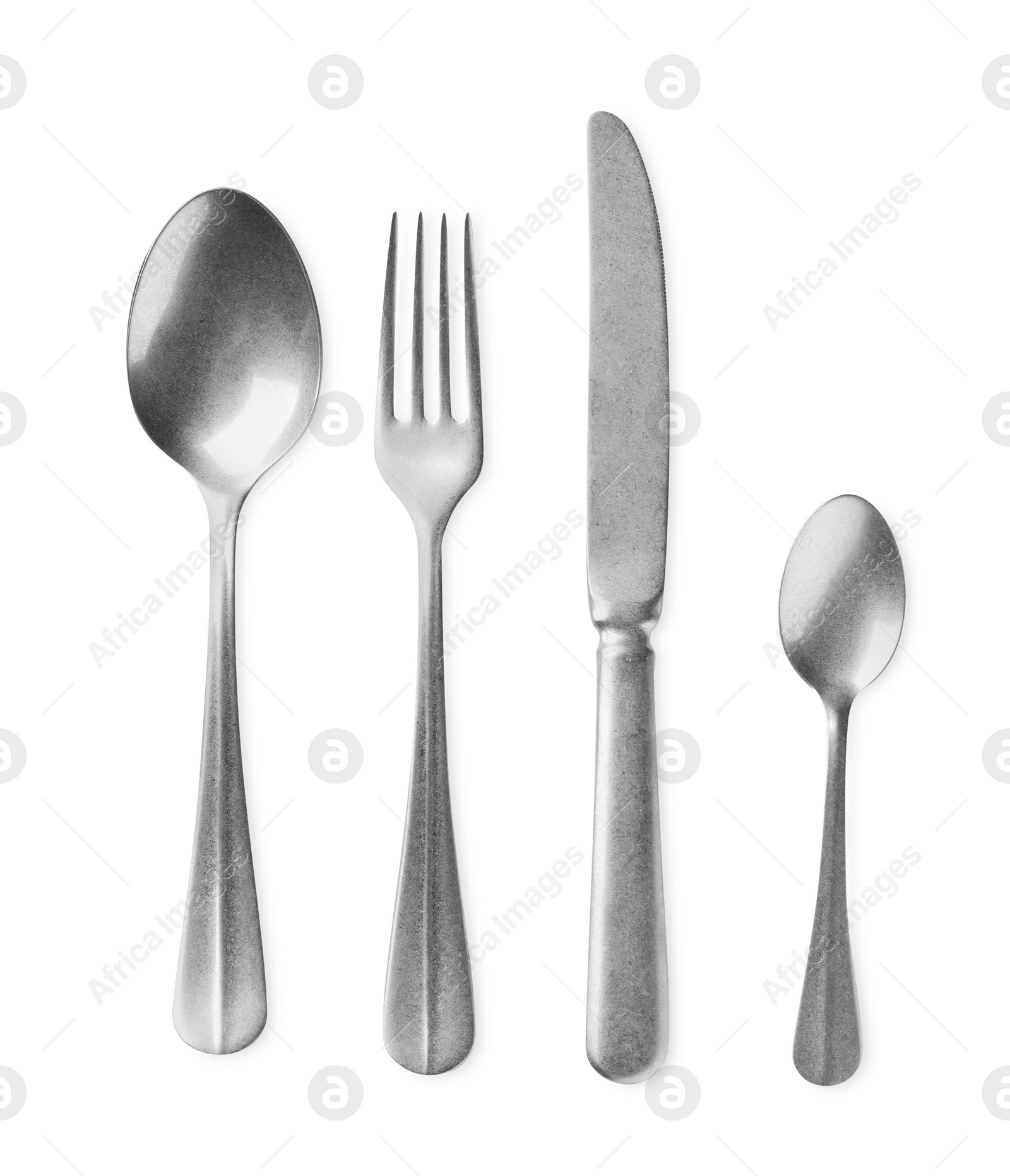 Photo of New shiny cutlery set on white background, top view
