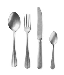 Photo of New shiny cutlery set on white background, top view