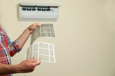 Image of Man holding dirty and clean filters, space for text. Home air conditioner cleaning