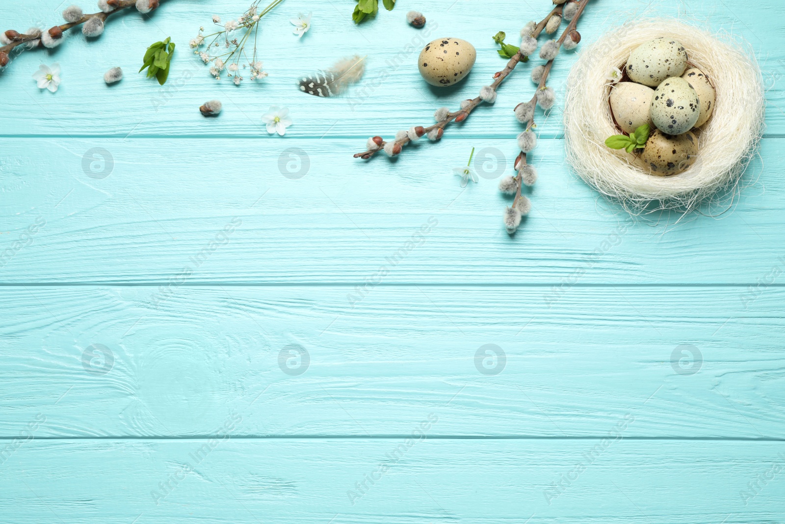 Photo of Flat lay composition with Easter eggs on light blue wooden background. Space for text