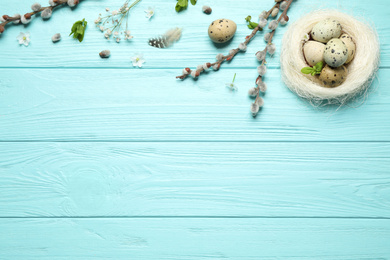 Photo of Flat lay composition with Easter eggs on light blue wooden background. Space for text