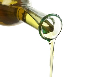 Pouring fresh olive oil on white background