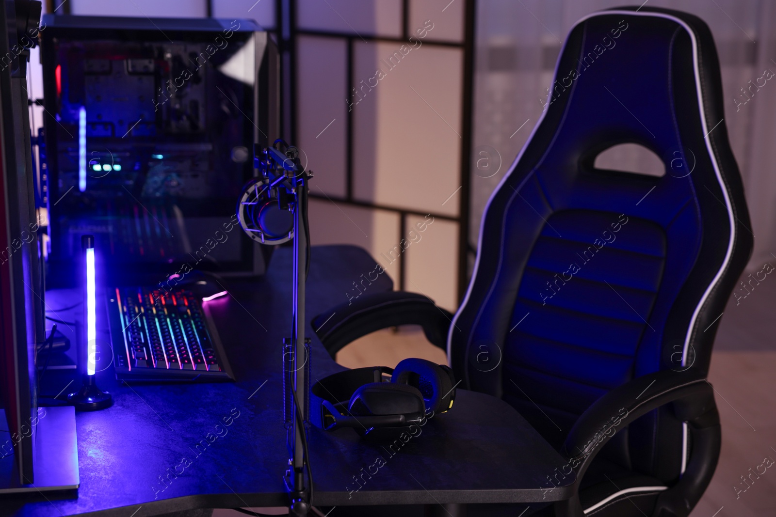 Photo of Playing video games. Modern computer and gaming chair indoors