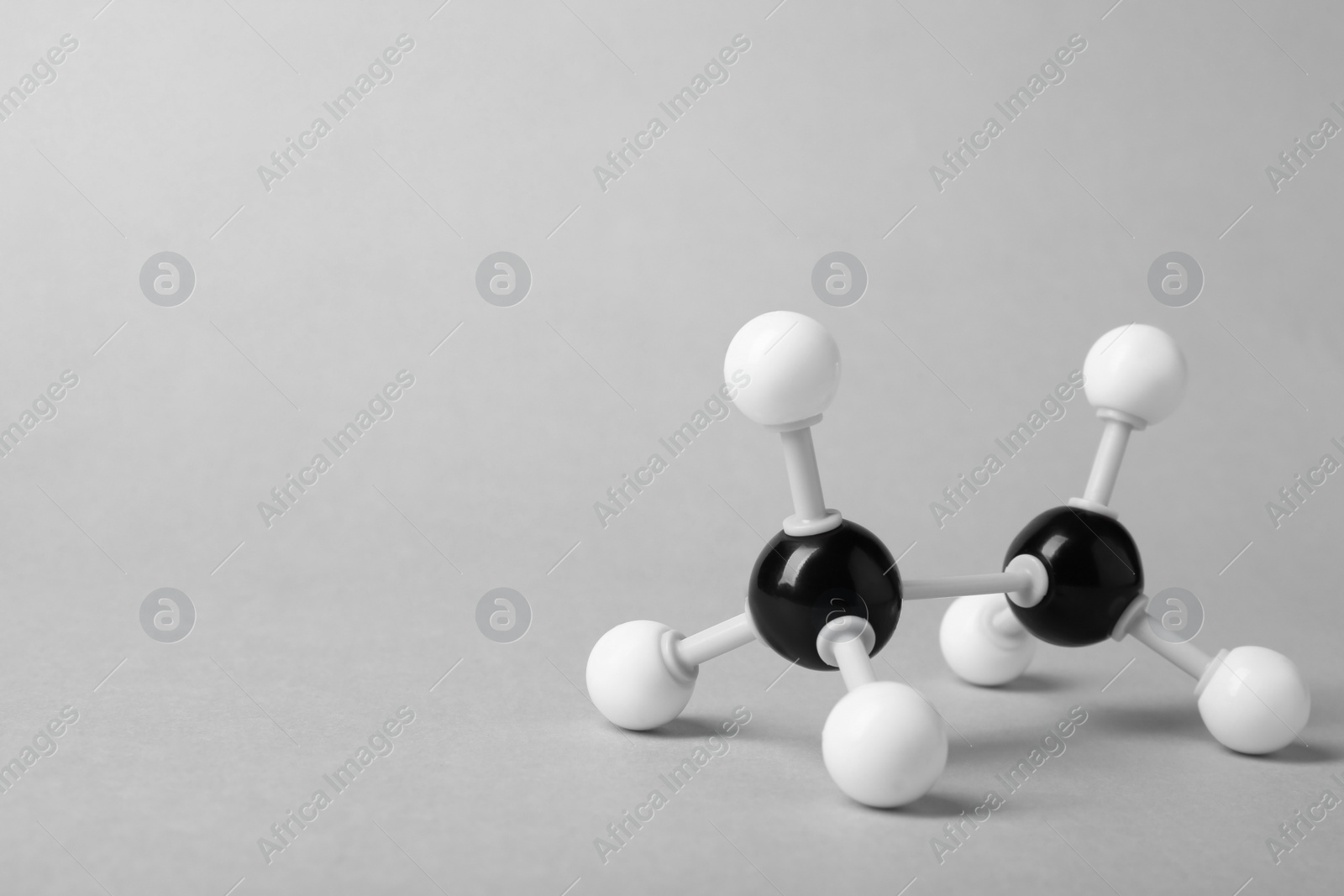 Photo of Molecule of alcohol on light grey background, space for text. Chemical model