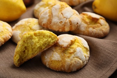 Photo of Delicious lemon cookies on brown towel, closeup