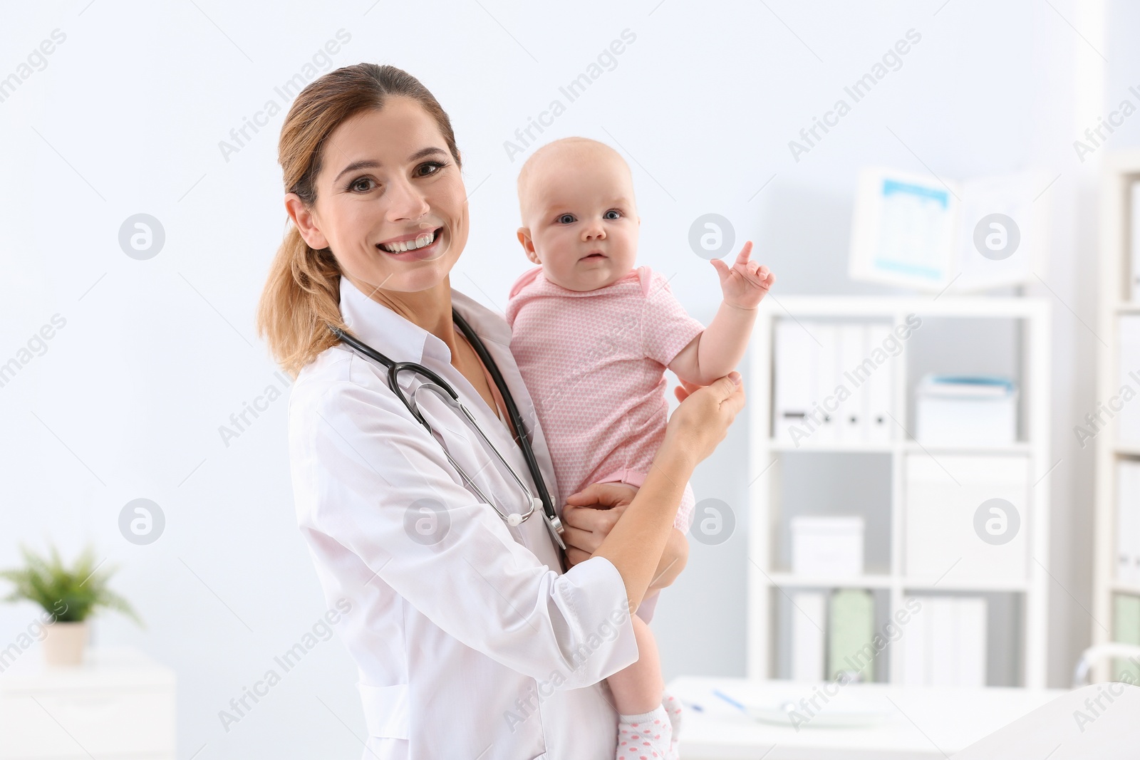 Photo of Children's doctor with cute baby in hospital