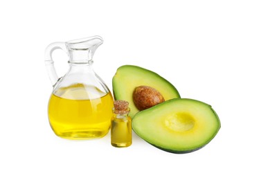 Photo of Oil and fresh cut avocado isolated on white