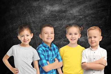 Image of Group of cute school children and chalkboard on background