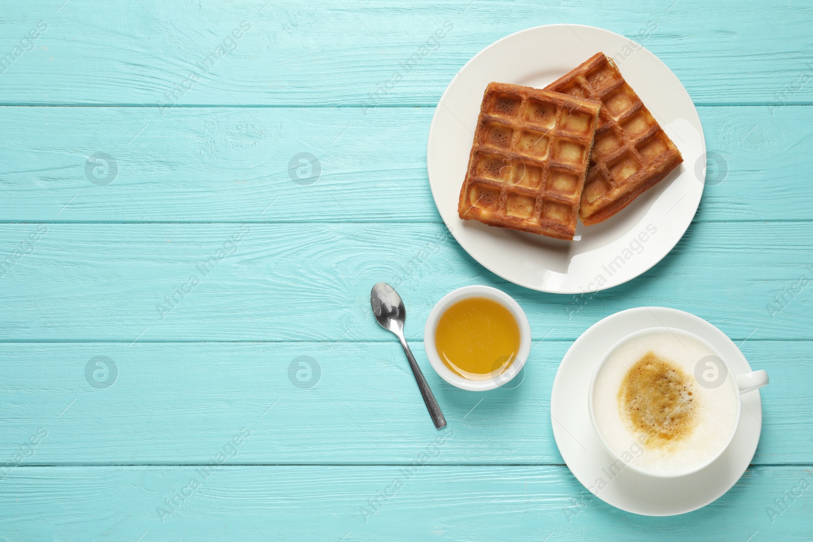 Photo of Tasty breakfast served on light blue wooden table, flat lay. Space for text