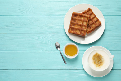 Tasty breakfast served on light blue wooden table, flat lay. Space for text