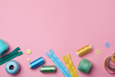 Photo of Flat lay composition with sewing threads on color background