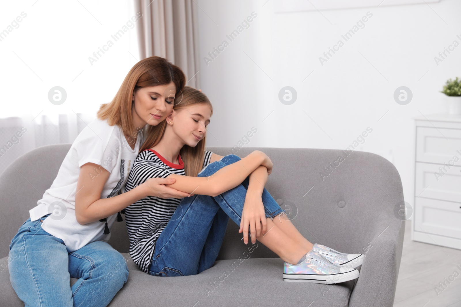 Photo of Happy mother hugging her teenager daughter at home
