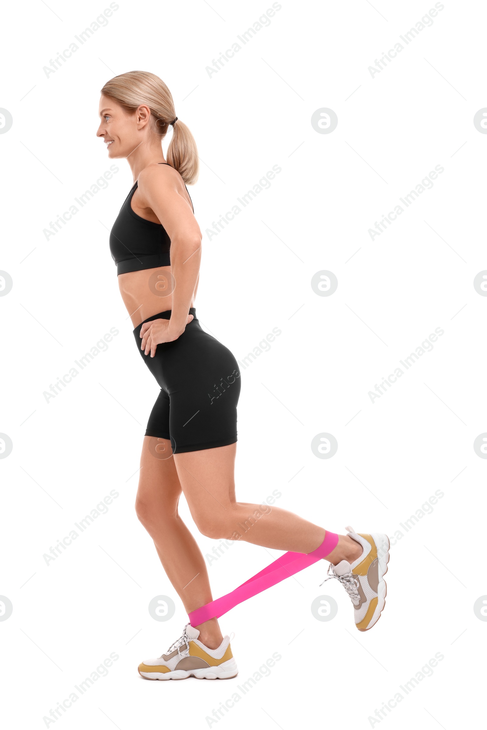 Photo of Woman exercising with elastic resistance band on white background