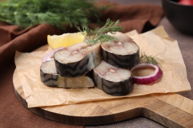 Photo of Slices of tasty salted mackerel and onion on table