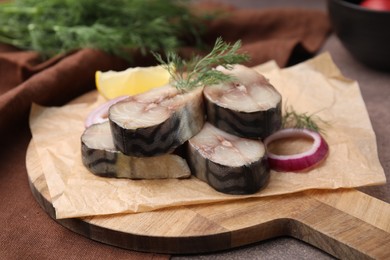 Slices of tasty salted mackerel and onion on table