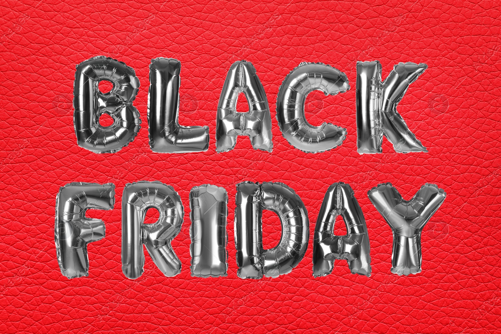 Image of Phrase BLACK FRIDAY made of foil balloon letters on red background