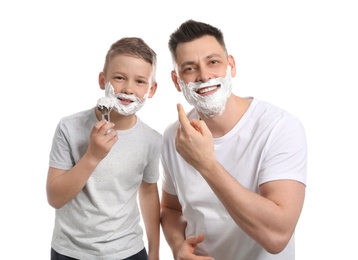 Photo of Dad and son applying shaving foam against white background