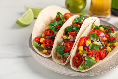 Photo of Tasty tacos with vegetables on white marble table, closeup