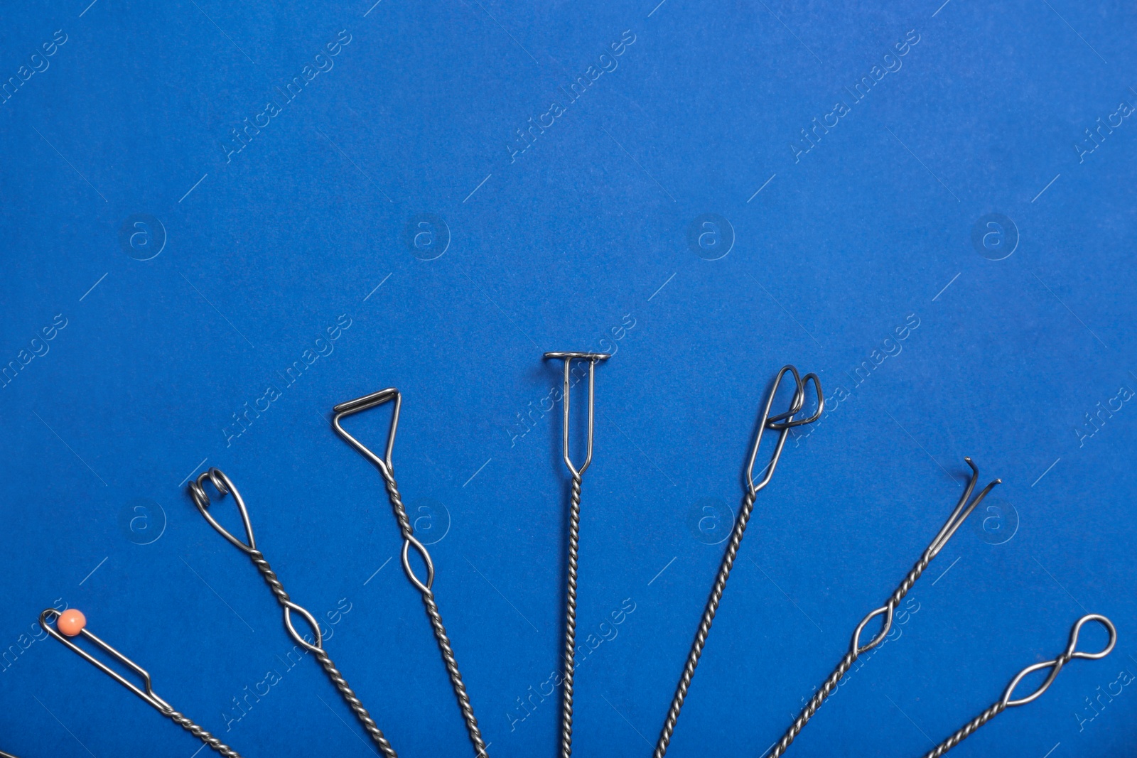 Photo of Set of logopedic probes for speech therapy on blue background, flat lay. Space for text