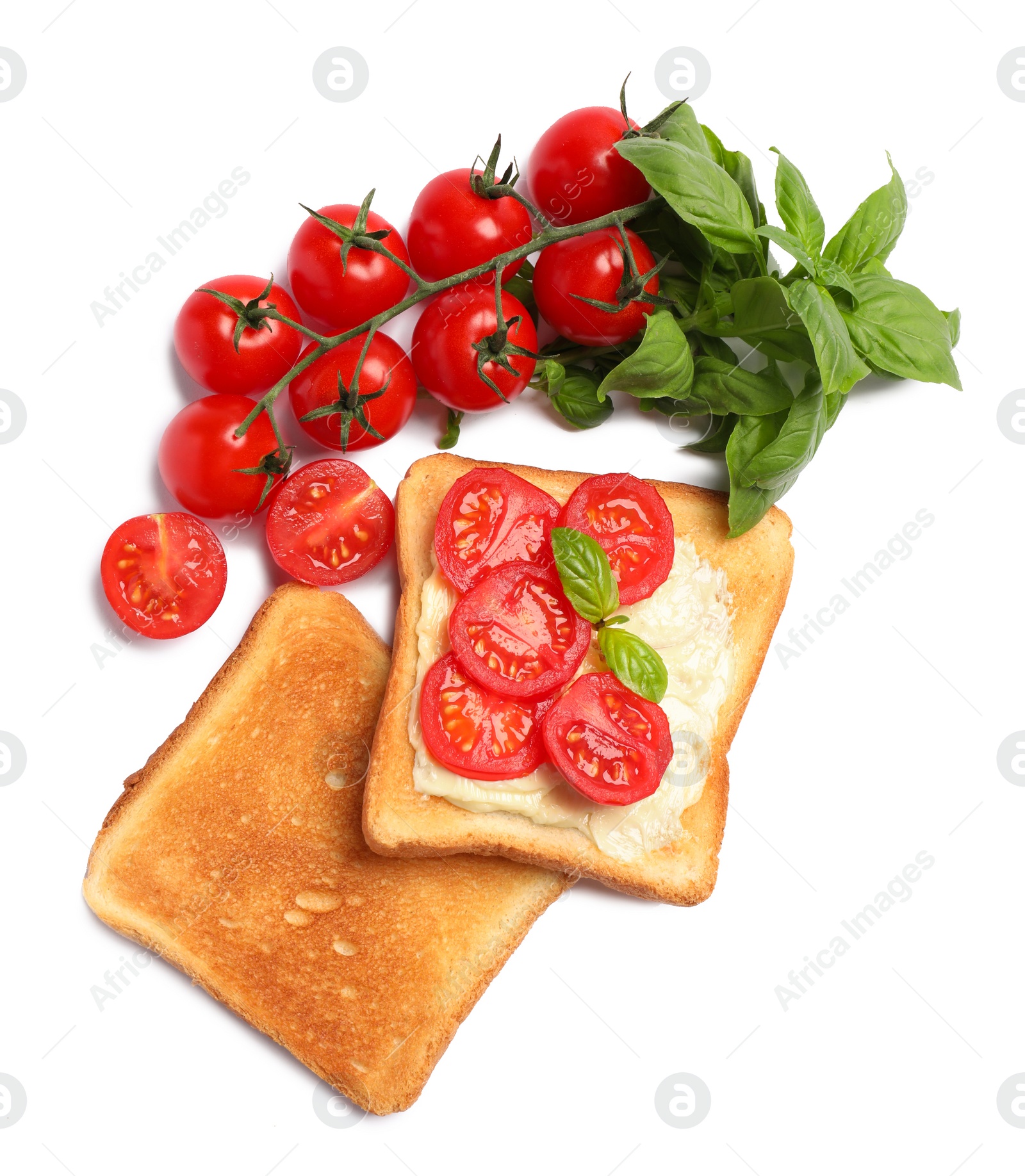 Photo of Delicious toasts with butter, tomatoes and basil isolated on white, top view